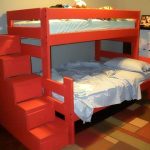 Un lit à deux niveaux avec une commode en rouge